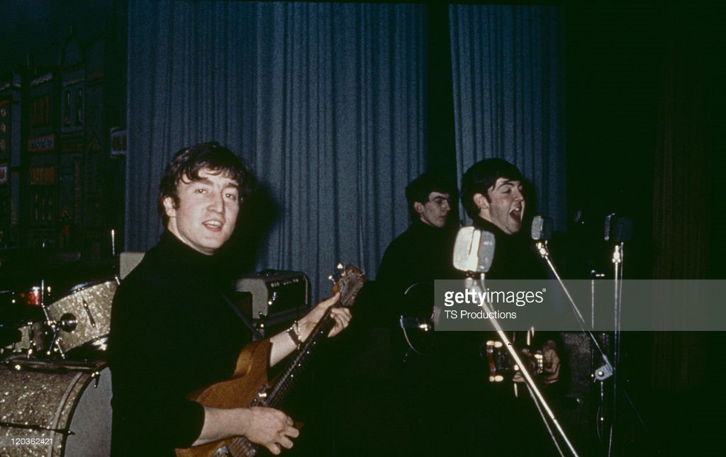 The Beatles performing on stage at the Star Club, Hamburg, April-May 1962. Left to right: John Lennon (1940 - 1980), George Harrison (1943 - 2001) and Paul McCartney - Credits : TS Productions